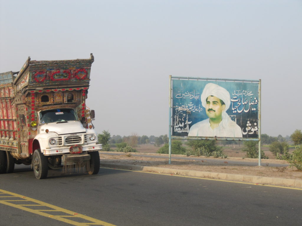 One of many signs depicting Faisal Saleh Hayat in his hometown of Shah Jewna. Photo: Umar Farooq.